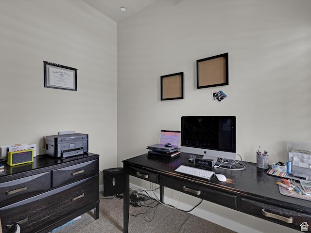carpeted home office with lofted ceiling