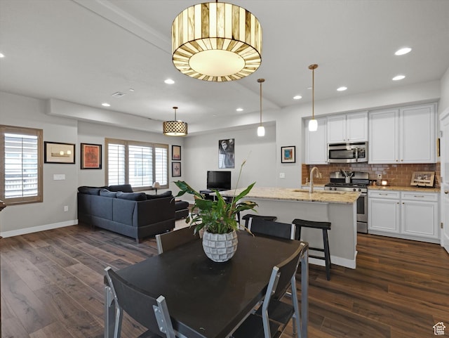 dining room with dark wood-type flooring and sink