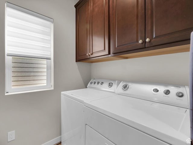laundry room featuring cabinets and separate washer and dryer