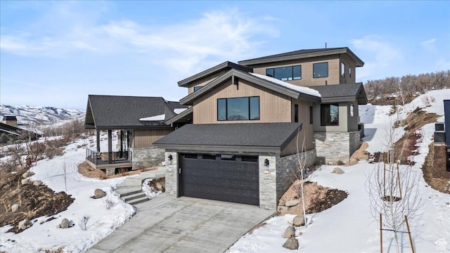 11432 N Fox Hollow Ct Unit 121, Hideout, UT 84036 - view of front facade with driveway, a shingled roof, an attached garage, and stone siding
