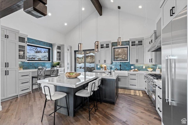 11432 N Fox Hollow Ct Unit 121, Hideout, UT 84036 - kitchen featuring stainless steel built in fridge, a breakfast bar area, a kitchen island, beamed ceiling, and wood finished floors