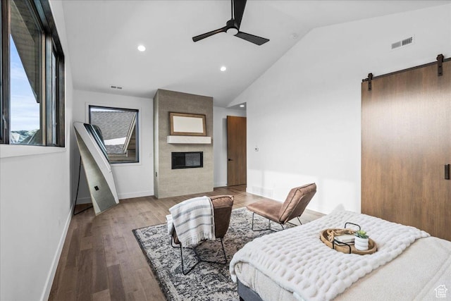 11432 N Fox Hollow Ct Unit 121, Hideout, UT 84036 - interior space featuring vaulted ceiling, a large fireplace, a barn door, visible vents, and wood finished floors