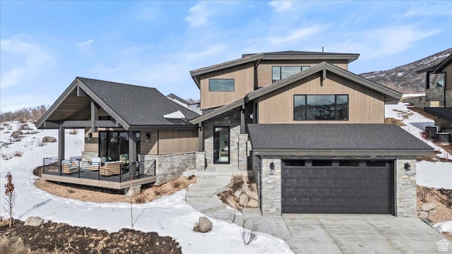 11432 N Fox Hollow Ct Unit 121, Hideout, UT 84036 - view of front of home featuring stone siding, a garage, and concrete driveway