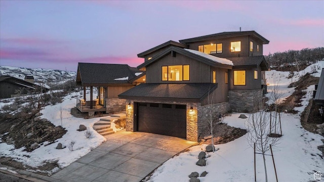 11432 N Fox Hollow Ct Unit 121, Hideout, UT 84036 - view of front of house featuring stone siding, an attached garage, and concrete driveway