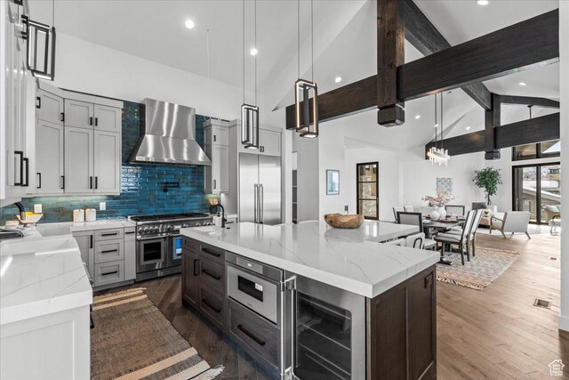 11432 N Fox Hollow Ct Unit 121, Hideout, UT 84036 - kitchen with wine cooler, backsplash, high quality appliances, beamed ceiling, and wall chimney range hood