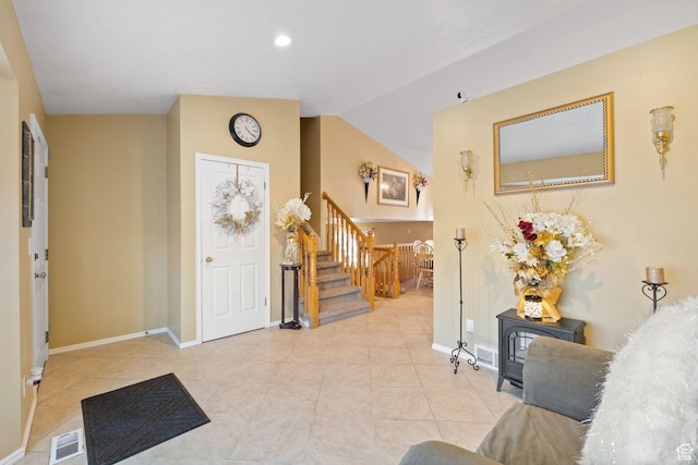 tiled foyer with baseboards, visible vents, recessed lighting, and stairs