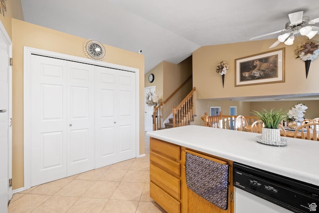 kitchen with lofted ceiling, light countertops, a ceiling fan, light tile patterned floors, and white dishwasher