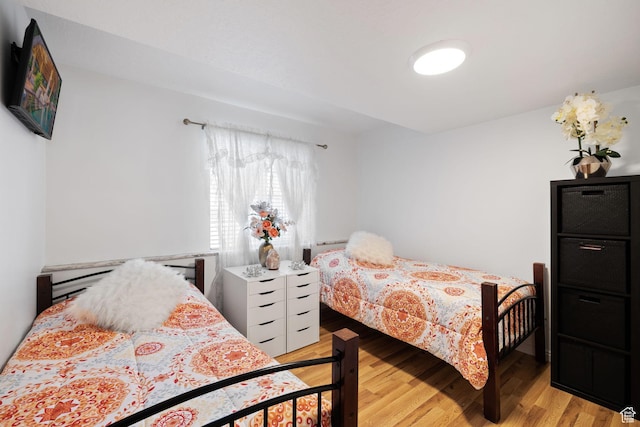 bedroom featuring light wood finished floors