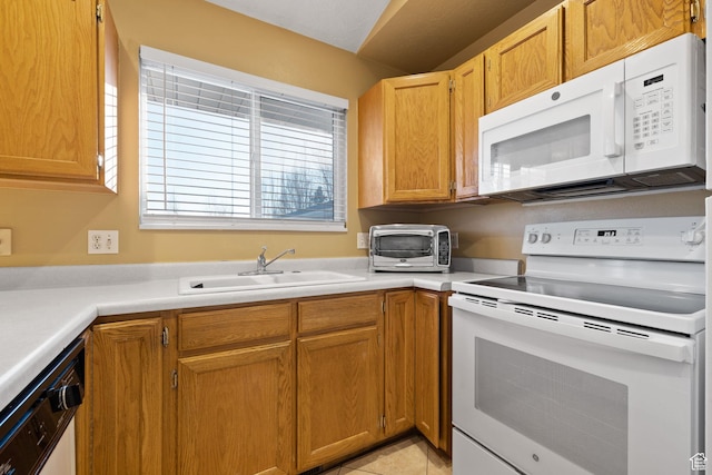 kitchen featuring light countertops, white appliances, a sink, and a toaster
