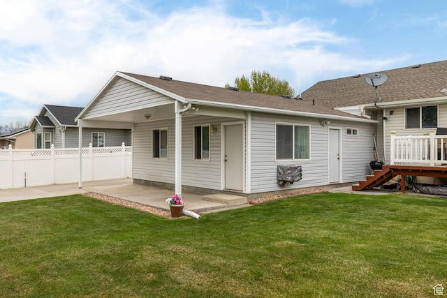 back of property featuring a lawn, a patio, and fence