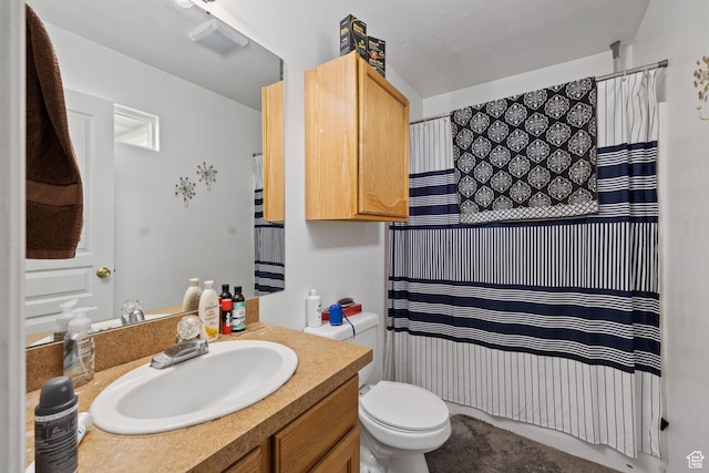 full bath featuring toilet, vanity, and a shower with curtain