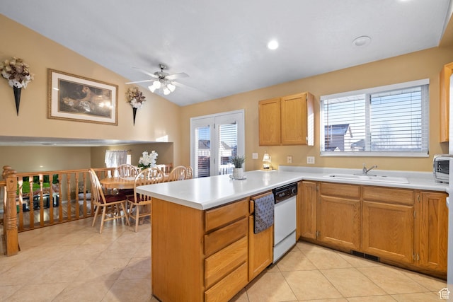 kitchen with light countertops, a sink, white dishwasher, a peninsula, and ceiling fan
