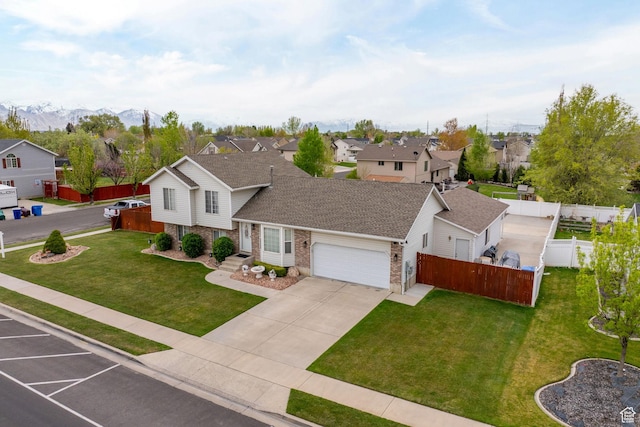 view of front of house with an attached garage, brick siding, a residential view, and a front yard