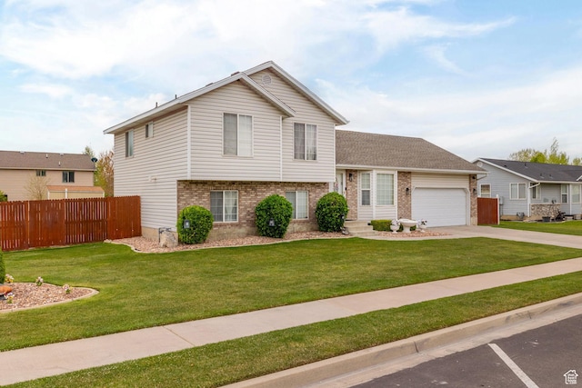 split level home featuring brick siding, fence, and a front yard