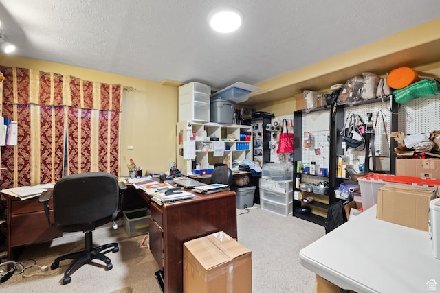office area with a textured ceiling and carpet