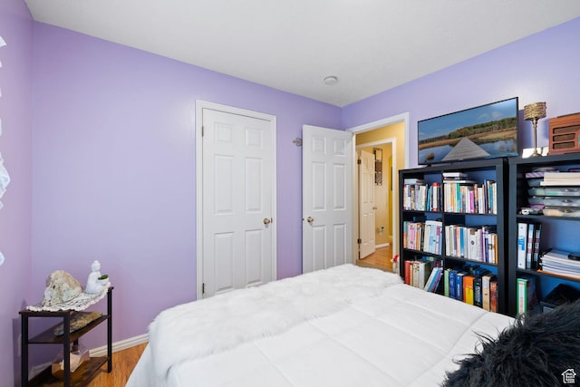bedroom with wood finished floors and baseboards