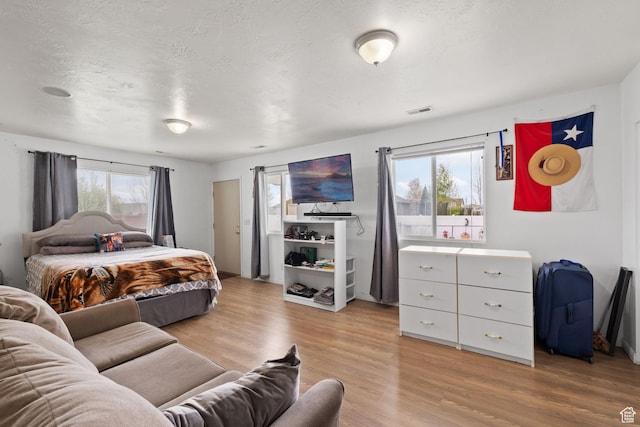bedroom featuring visible vents and light wood-type flooring