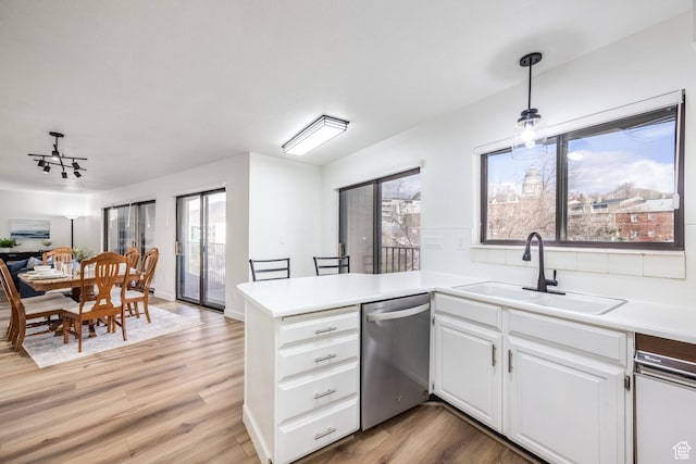 245 N Vine St W Unit 501, Salt Lake City, UT 84103 - kitchen with sink, hanging light fixtures, dishwasher, kitchen peninsula, and white cabinets