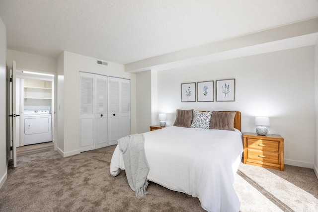 245 N Vine St W Unit 501, Salt Lake City, UT 84103 - carpeted bedroom with washer / clothes dryer, a closet, and a textured ceiling