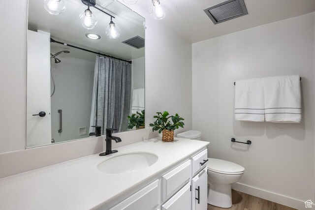 245 N Vine St W Unit 501, Salt Lake City, UT 84103 - bathroom with hardwood / wood-style flooring, vanity, toilet, and curtained shower