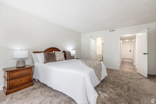 245 N Vine St W Unit 501, Salt Lake City, UT 84103 - carpeted bedroom featuring ensuite bath and a textured ceiling
