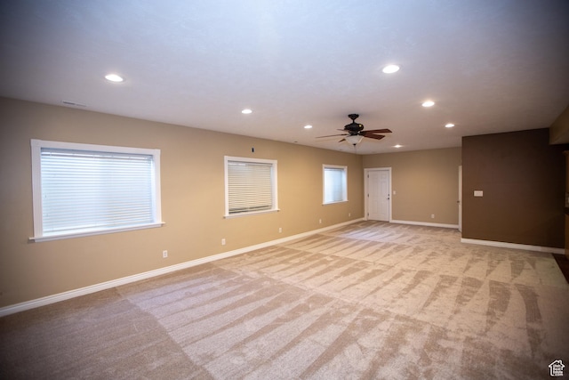 unfurnished room with light carpet, recessed lighting, and baseboards