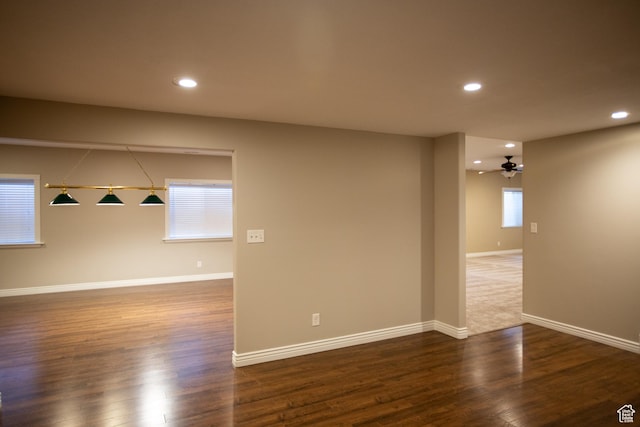 spare room featuring a ceiling fan, baseboards, wood finished floors, and recessed lighting