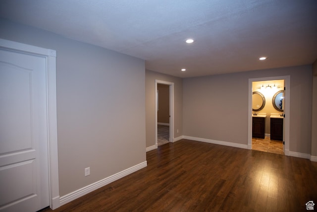 unfurnished room with recessed lighting, dark wood finished floors, and baseboards