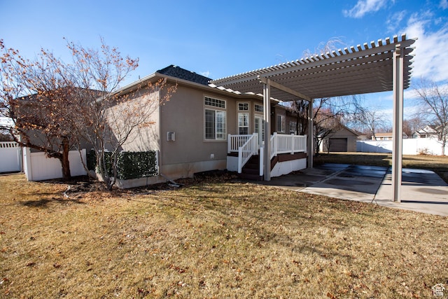 exterior space with a yard, fence, driveway, and a pergola