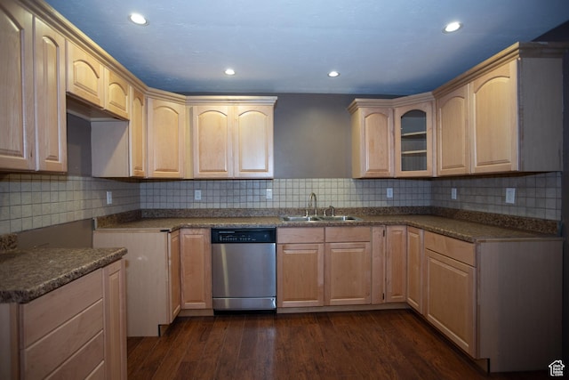 kitchen with dark wood-style floors, light brown cabinetry, stainless steel dishwasher, and a sink