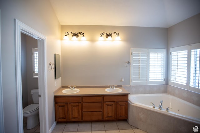 bathroom featuring a garden tub, a sink, toilet, and tile patterned floors
