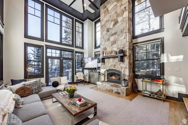2350 W Red Pine Ct, Park City, UT 84098 - living room with a high ceiling, a stone fireplace, wood finished floors, beamed ceiling, and baseboards
