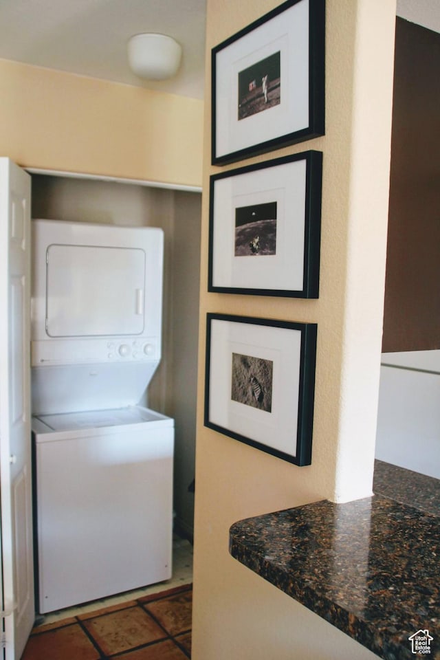 3280 E Fairway Loop Unit 10-B, Moab, UT 84532 - laundry area featuring stacked washer / drying machine and dark tile patterned flooring