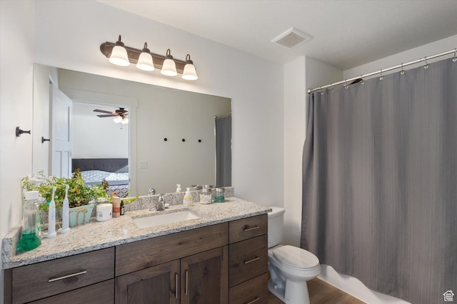 bathroom featuring vanity, ceiling fan, and toilet