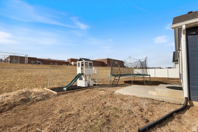 view of yard with a playground, a trampoline, and a patio area