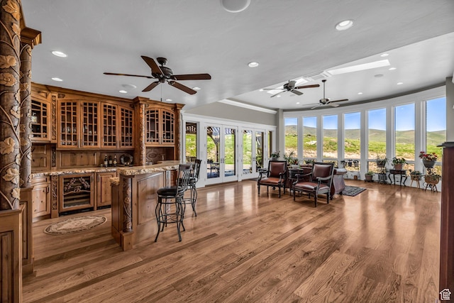 2410 E Center Creek Rd, Heber City, UT 84032 - interior space with light stone counters, crown molding, wood-type flooring, ceiling fan, and beverage cooler