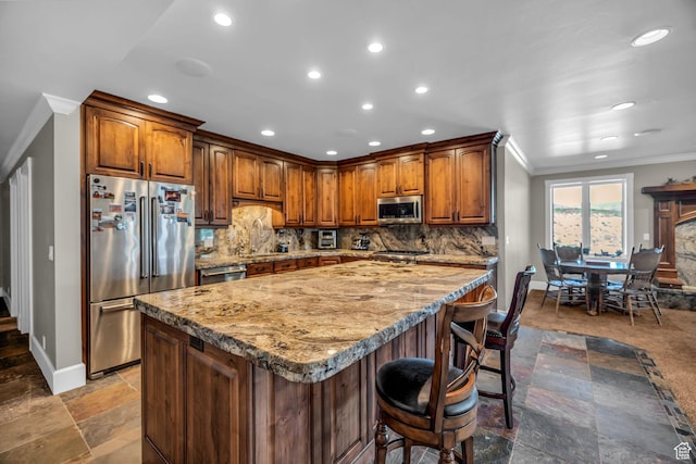 2410 E Center Creek Rd, Heber City, UT 84032 - kitchen with stainless steel appliances, crown molding, a breakfast bar, and backsplash