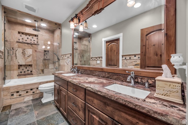 2410 E Center Creek Rd, Heber City, UT 84032 - full bathroom featuring shower / bath combination with glass door, vanity, toilet, and tile walls