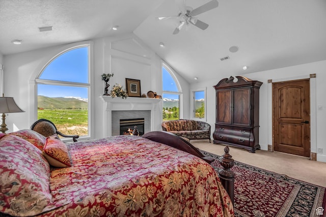 2410 E Center Creek Rd, Heber City, UT 84032 - carpeted bedroom with high vaulted ceiling, a fireplace, ceiling fan, a mountain view, and a textured ceiling