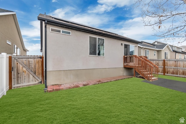 rear view of house featuring a lawn
