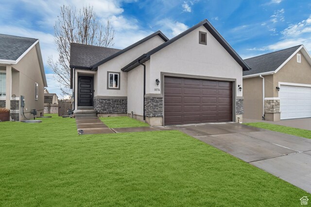 view of front of property with a garage and a front lawn