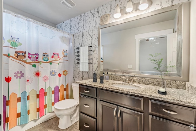 bathroom with a shower with curtain, vanity, and toilet