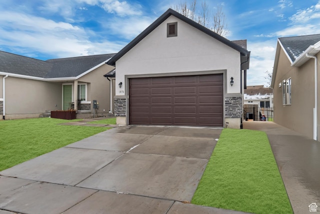 view of front of house featuring a garage and a front lawn