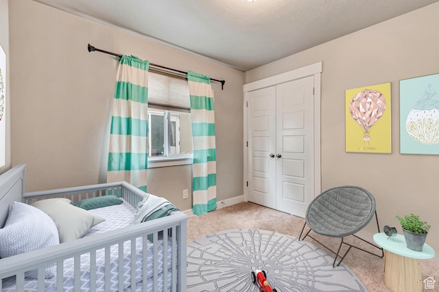 bedroom with light colored carpet and a closet