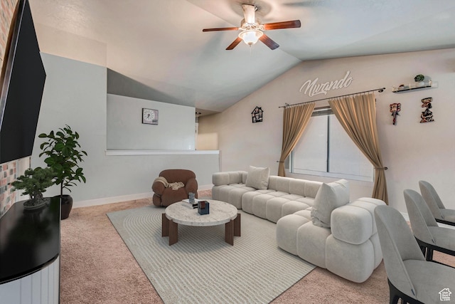 living room with ceiling fan, lofted ceiling, and light carpet