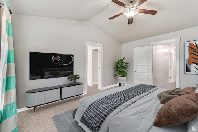 bedroom with ceiling fan, vaulted ceiling, and light carpet
