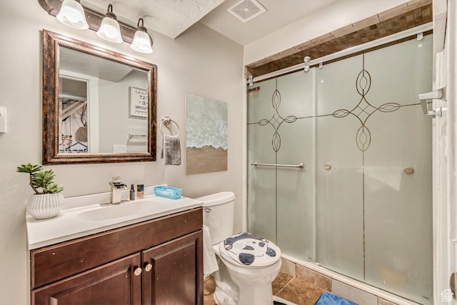 bathroom with walk in shower, vanity, and toilet