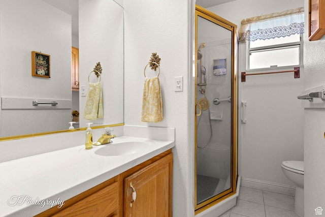 bathroom featuring tile patterned flooring, vanity, a shower with door, and toilet