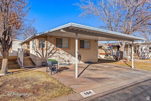 view of front of property featuring a carport