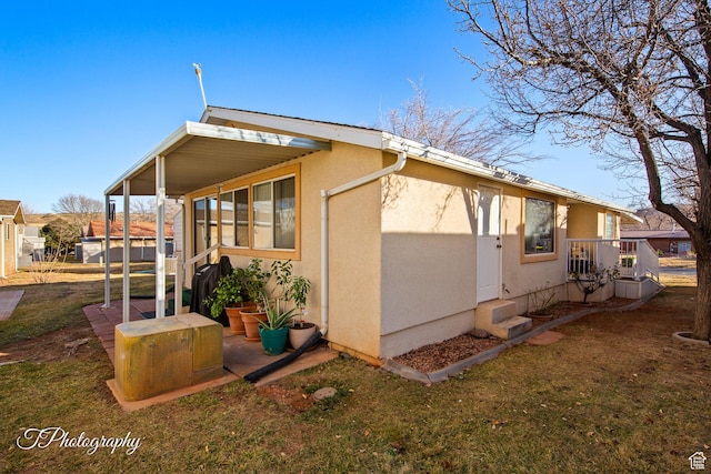 view of side of home with a yard